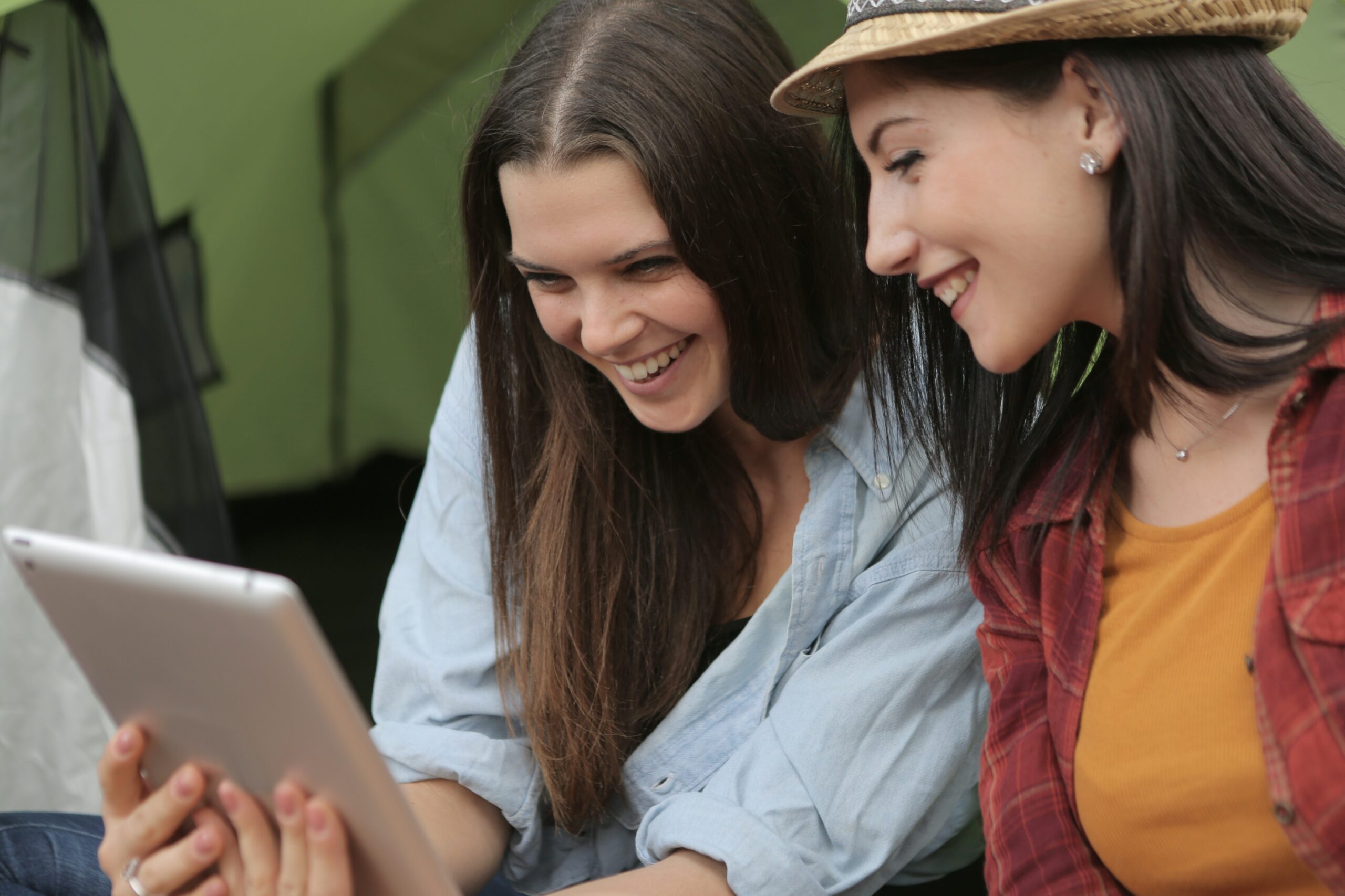 Women smiling while looking at iPad